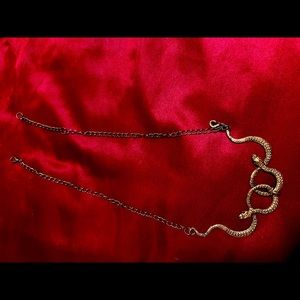 A brass double snake necklace